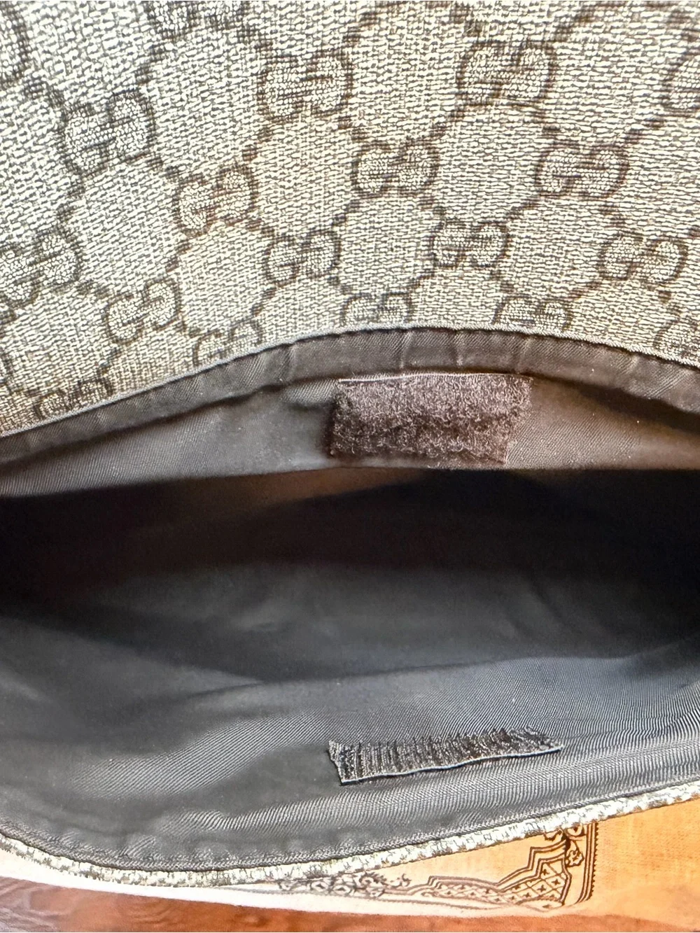 GG Supreme canvas diaper bag, designed with multiple pockets and fold-out pad